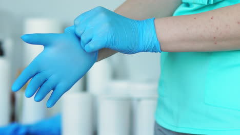 close-up of the doctor wearing rubber gloves