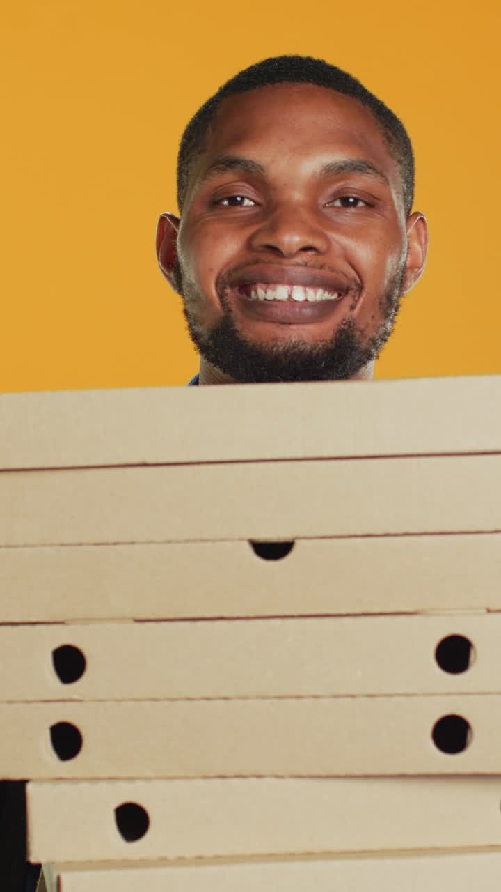 Smiling African American Delivery Man Holding Pizza Boxes