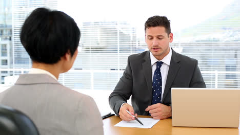 Handsome-businessman-conducting-an-interview-with-businesswoman