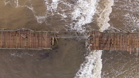 wooden pier damaged by heavy storm waves at the capitola wharf in california, usa