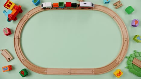 childish toy wooden railway. toy train travel along the ring railway. child's educational toys. top view. copy space