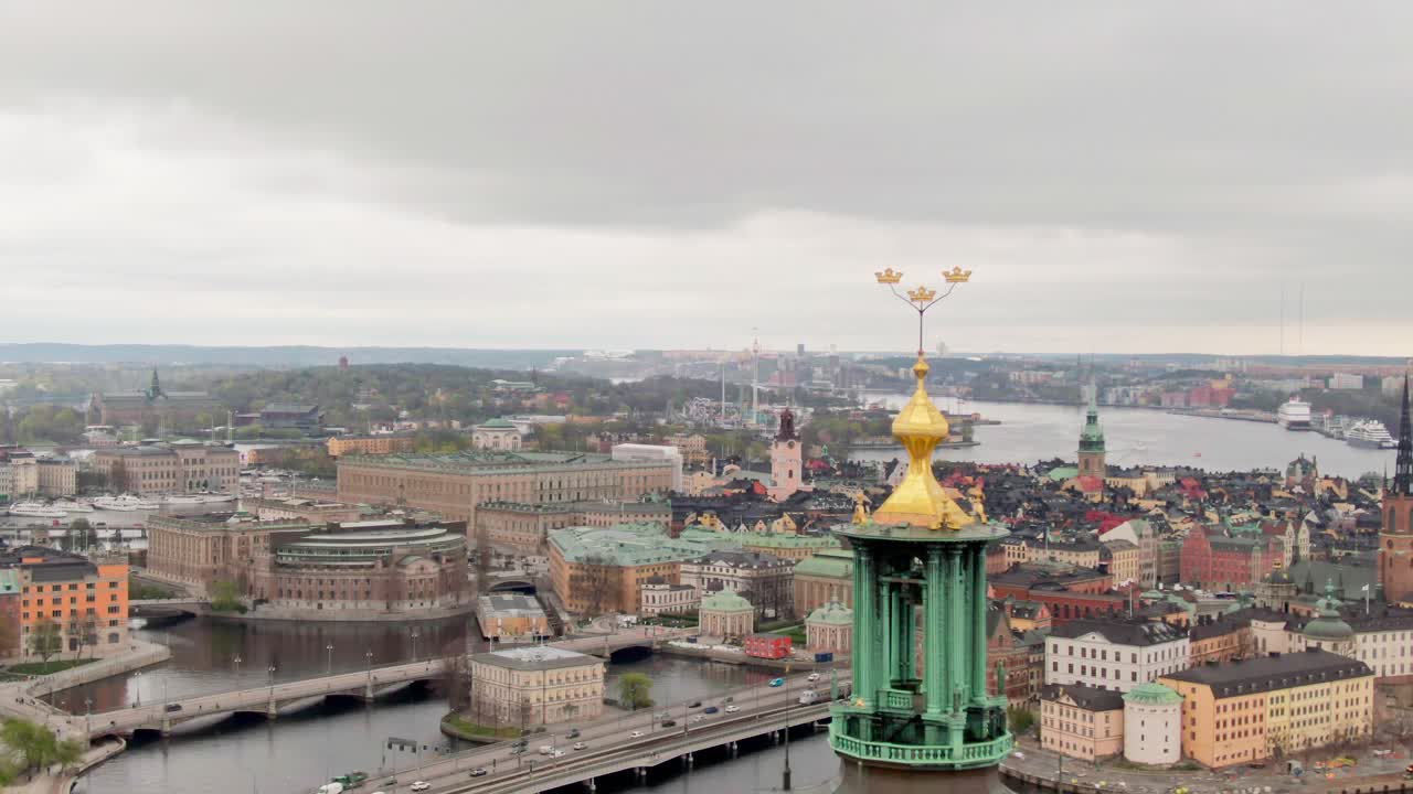 Aerial drone shot gliding over Stockholm’s skyline, passing above the iconic City Hall tower