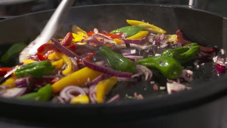 close up shot of a pot of vegetables being stirred while cooking