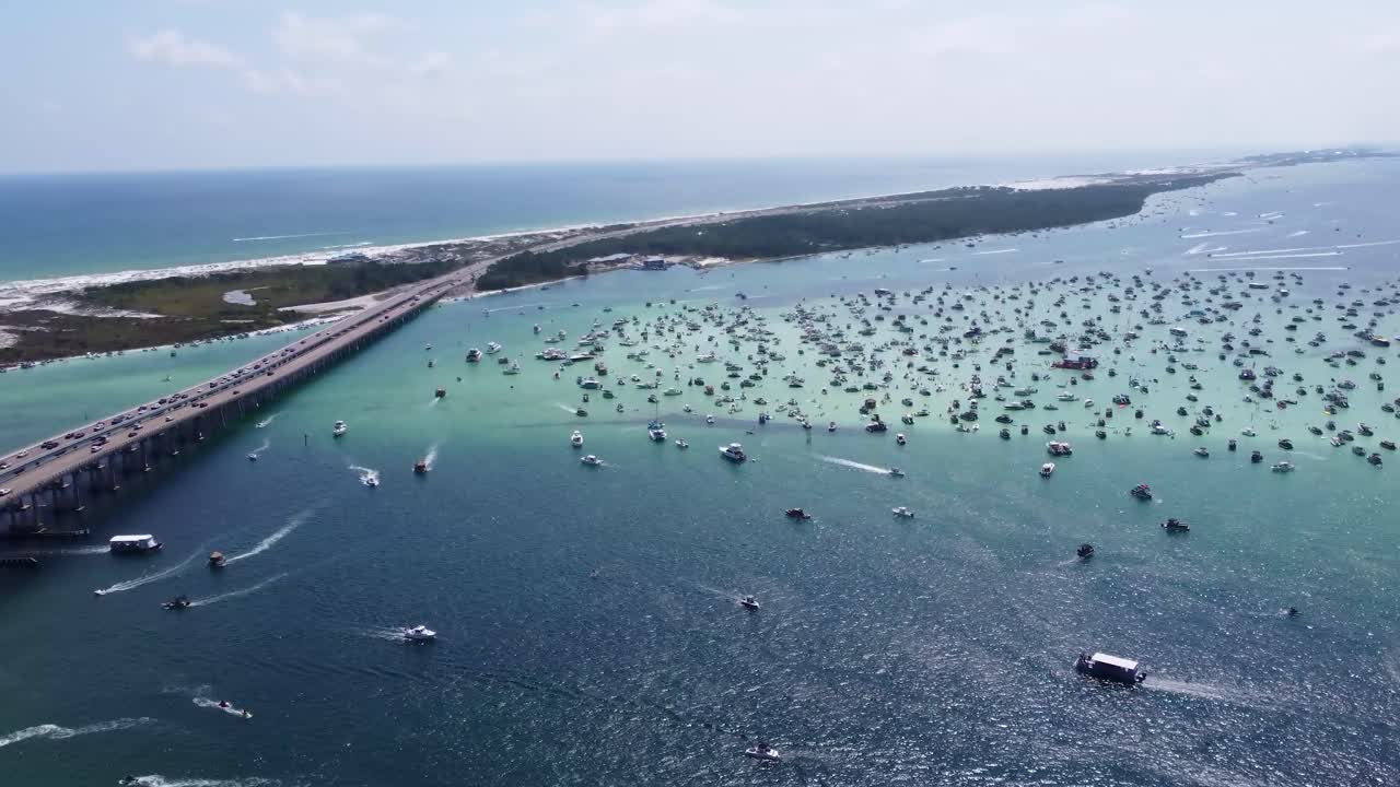 Aerial view of Crab Island, Destin Florida. Crab Island, Destin Fl. Crowd of people with their pontoon boats, yachts at Crab Island in Destin, Florida during high tide with turquois blue water