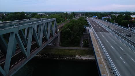 drone flying between a railroad and an automobile bridge in central europe spanning over the rhine rhiver