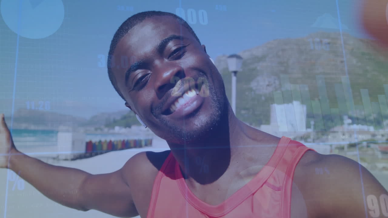 Smiling man in red tank top with data processing animation over beach background
