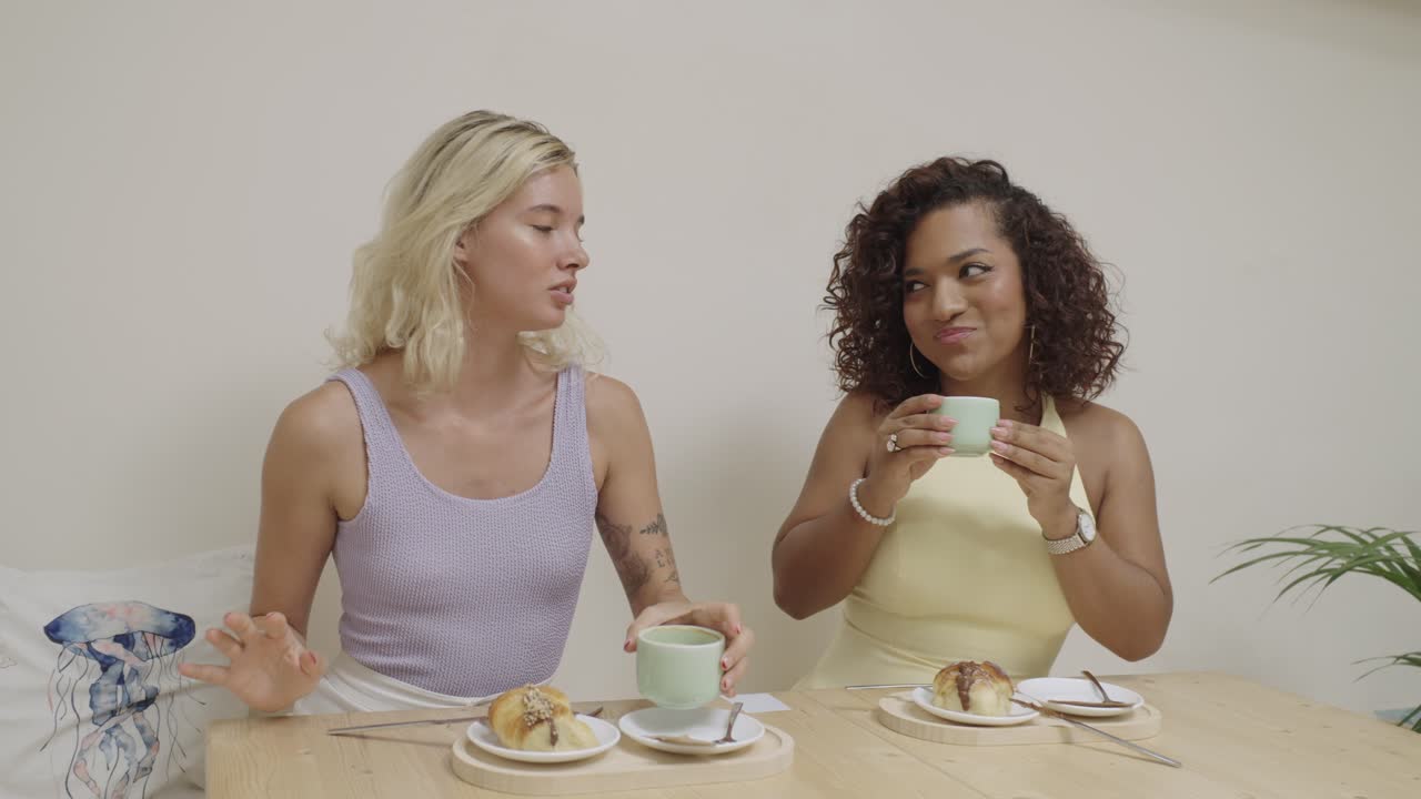 Two women drinking tea at a table