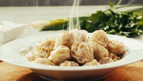 steaming hot dumplings in a white bowl