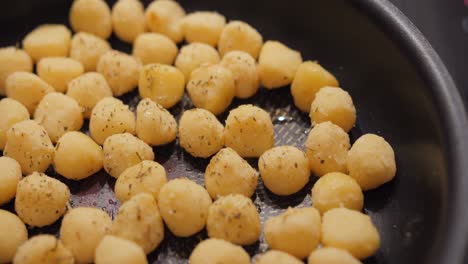 detalied shot of homemade gnocchis being fried in big pan