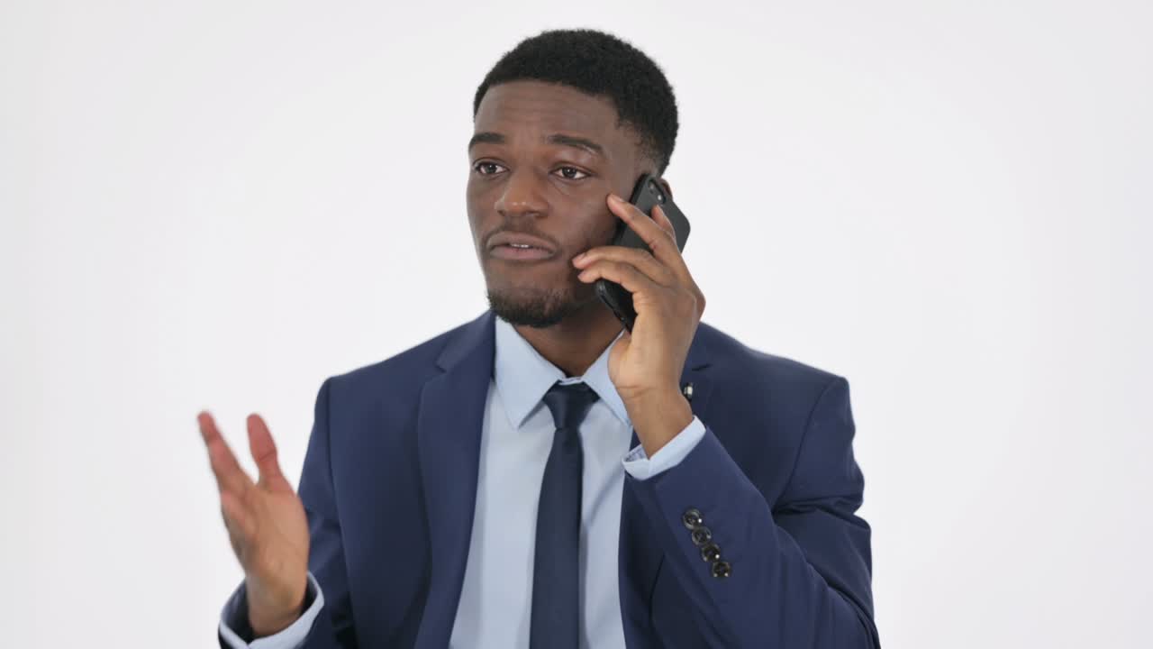 Aggressive African Businessman Angry on Phone on White Background