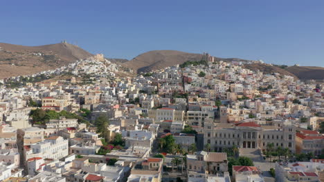 Aerial:-Slow-panning-drone-shot-of-Ermoupoli-in-Syros,-Greece-during-sunrise