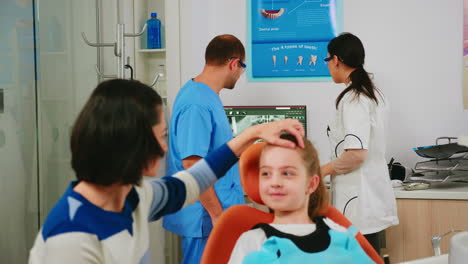 team of stomatologist doctors analysing teeth x-ray of little patient