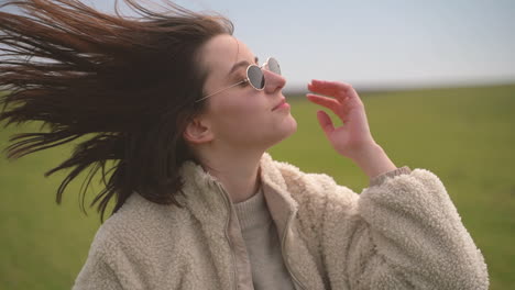 A-Young-Beautiful-Brunette-Girl-Walks-Through-A-Green-Meadow-3