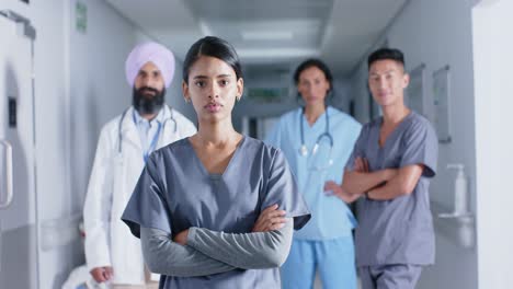 Portrait-of-diverse-doctors-and-nurses-in-corridor-at-hospital,-in-slow-motion