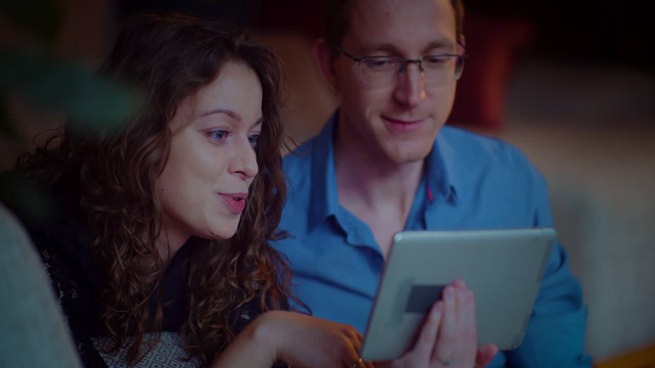 Couple using tablet together indoors