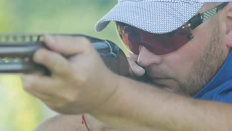 sportsman shoots from a double-barreled shotgun, a sports field for a shooting test is shooting at flying skeet