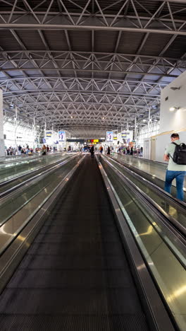 passengers walking in airport terminal in vertical