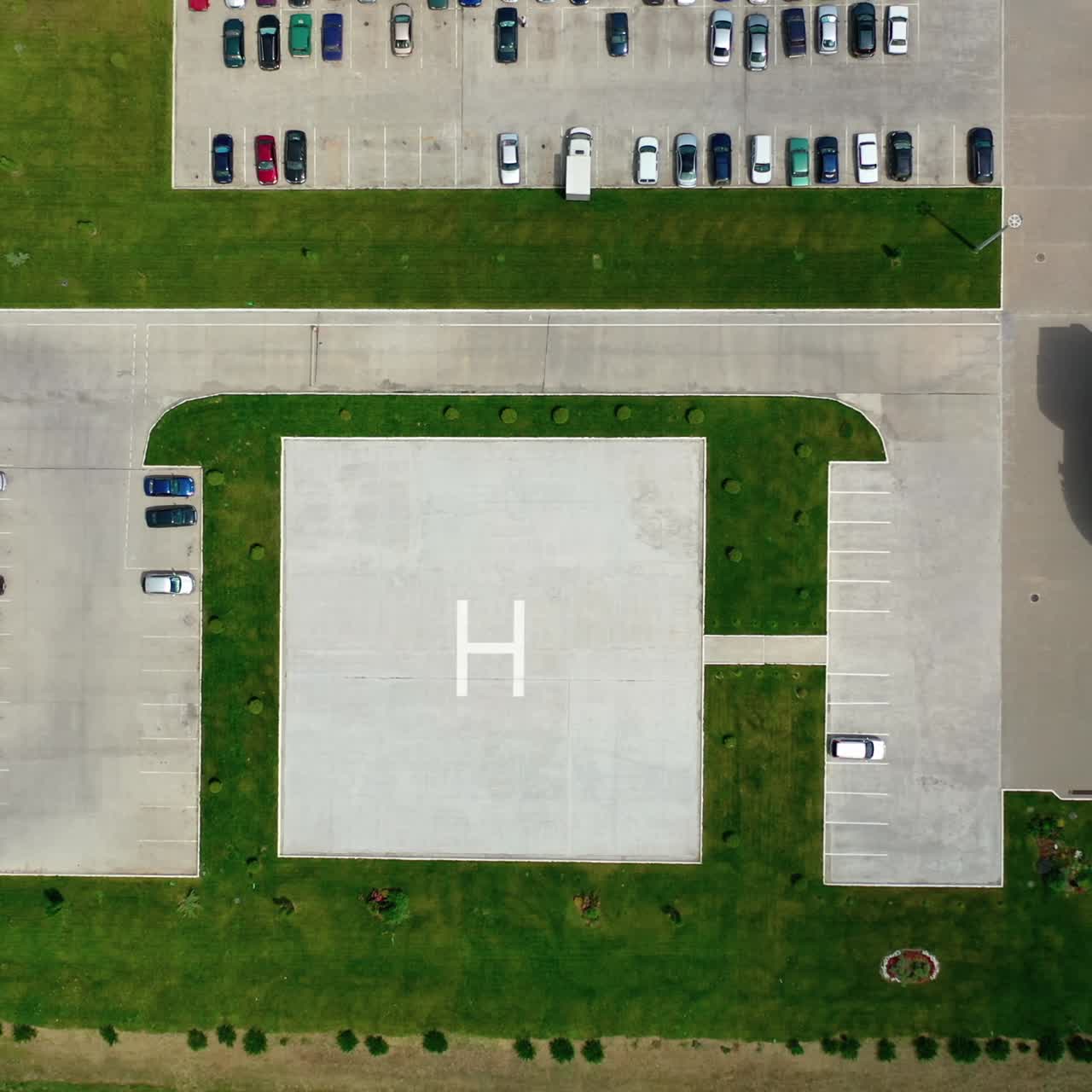 Parking spaces on greenfield. Territory of a plant with car parking. Top view. Camera moves down