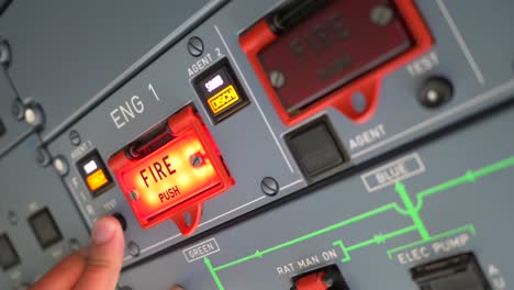 hand of pilot pushing button for engine fire test airbus a319 a320 a321,preparing flight on ground