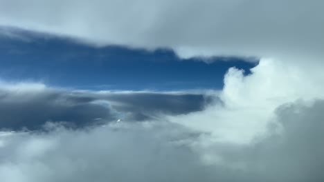 Unique-view-recorded-from-a-jet-cabin-while-flying-through-a-turbulent-sky-looking-for-a-path-to-cross-bad-weather