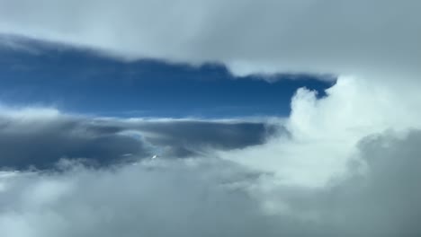 unique view recorded from a jet cabin while flying through a turbulent sky looking for a path to cross bad weather