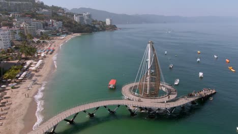 playa de los muertos beach and pier close to puerto vallarta malecon in mexico - aerial drone shot