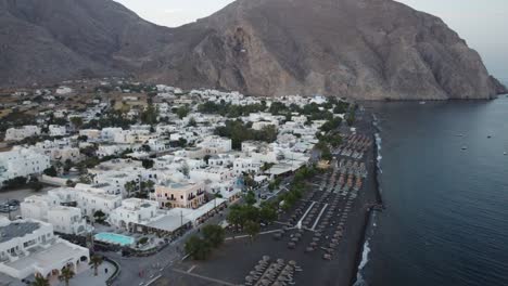 looking across the black sands in santorini at sunset