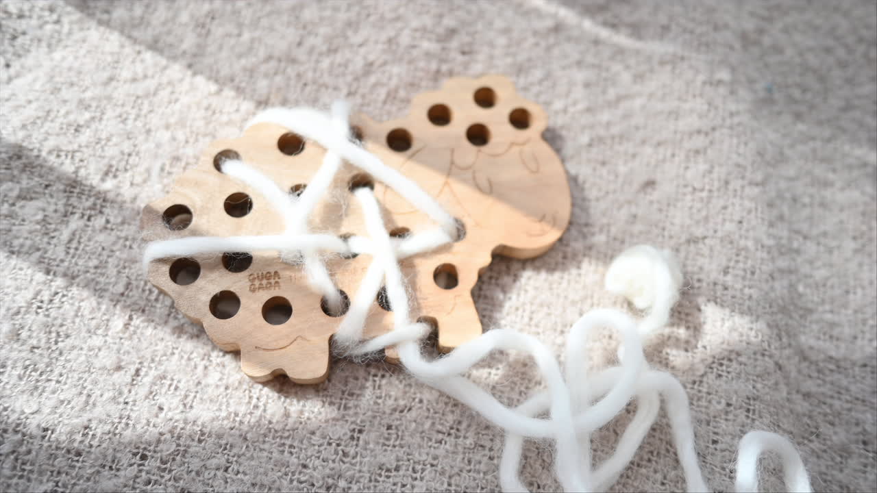 Ecological wooden sheep with a white string toy