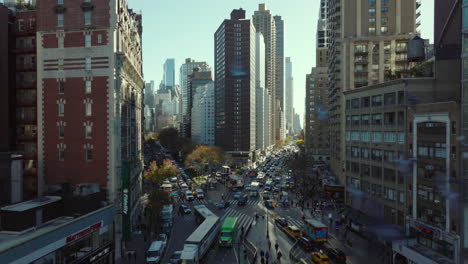 Traffic-jam-in-streets-of-large-city.-Slowly-moving-or-waiting-vehicles-in-queue.-Road-intersection-in-rush-hour.-Manhattan,-New-York-City,-USA