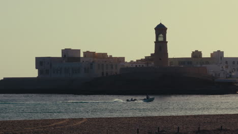 coastal town in oman at sunset