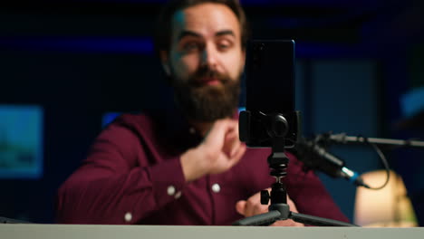 focus on smartphone attached to tripod used by online star