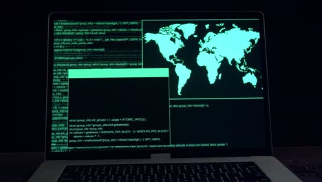 hacker concept. code on a laptop computer monitor in a dark room