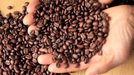 Geröstete-Braune-Kaffeebohnen-In-Einem-Haufen-Mit-Der-Hand-Stockvideo