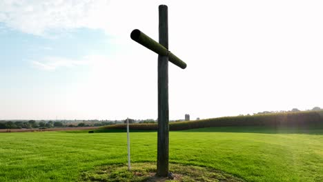 cross in rural countryside representing jesus crucifixion and death, resurrection