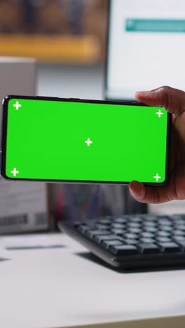 vertical video staff reviews green screen pc in the storage room for data entry