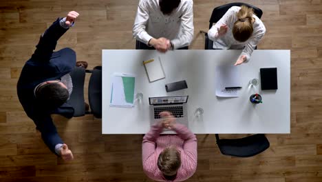 boss coming in and showing results, business people cheering, topshot, team of winner enjoying their victory, sitting in modern office