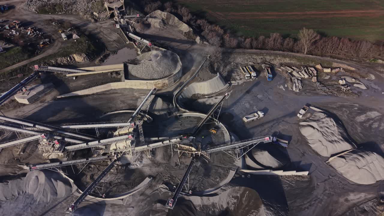 Working area in a large quarry during day with machinery in action