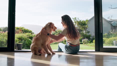 woman petting her dog at home