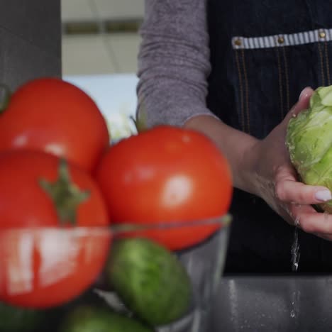 woman washes ingredients for salad 1