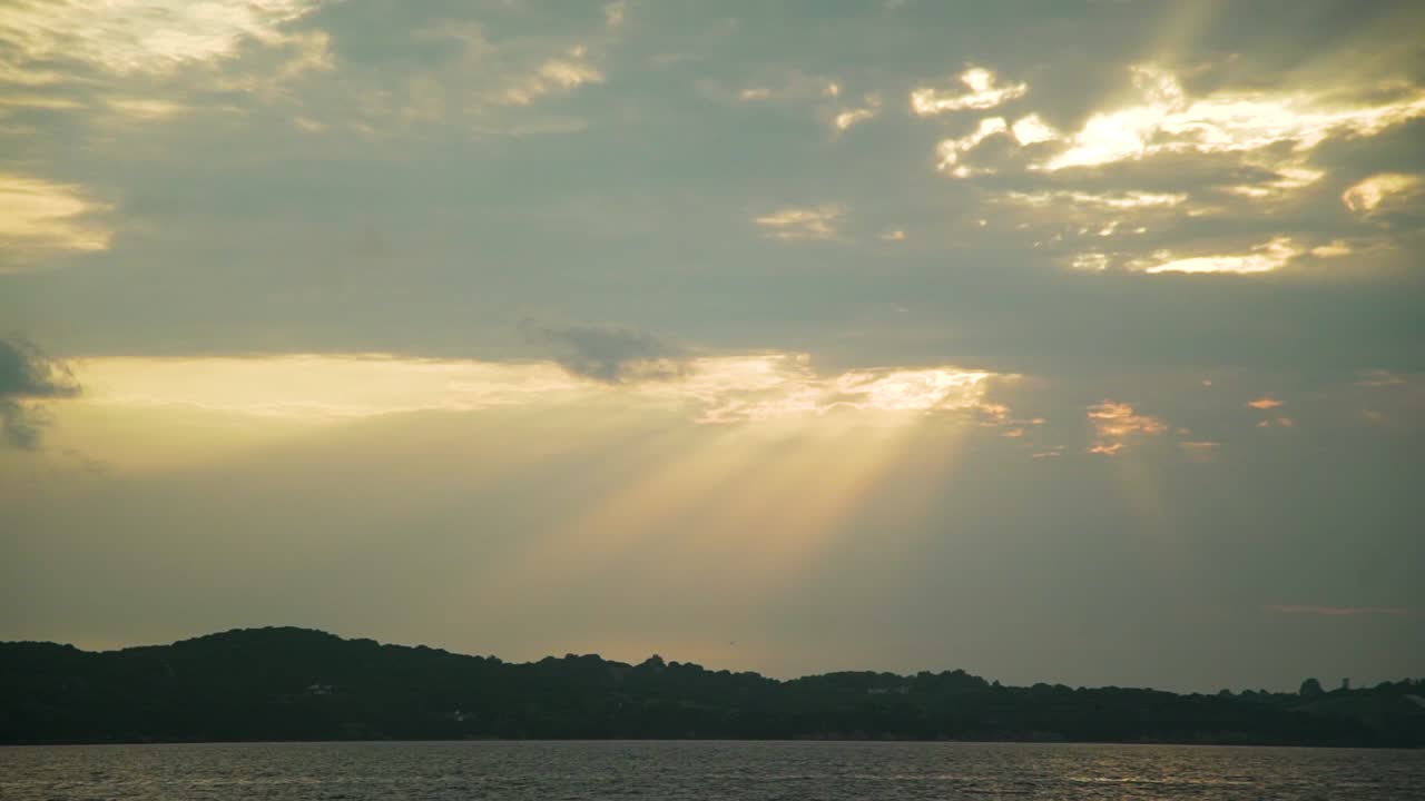 sun behind clouds amazing colours at sky with sea view and mountain at background idyllic shot