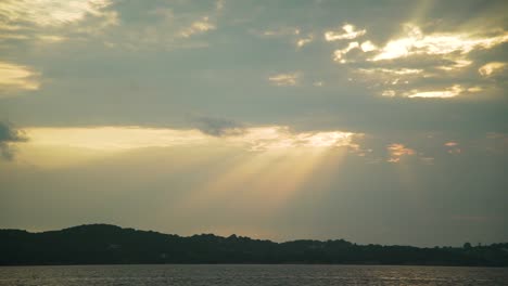 sun behind clouds amazing colours at sky with sea view and mountain at background idyllic shot