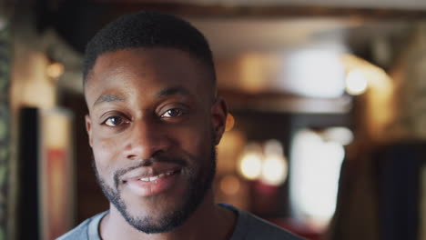 head and shoulders portrait of smiling man inside hotel