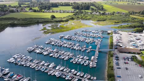Aerial-drone-view-of-yachts-moored-at-the-dock-on-the-coastline-of-Hayling-Island-in-England,-United-Kingdom