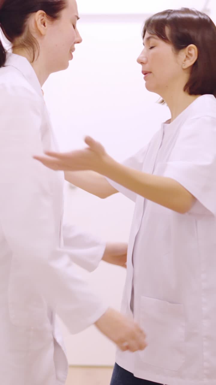 Worried doctor supported by a colleague in the clinic