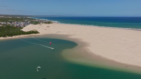 aerial view of sandy beach with kite surfers in witsand, south africa