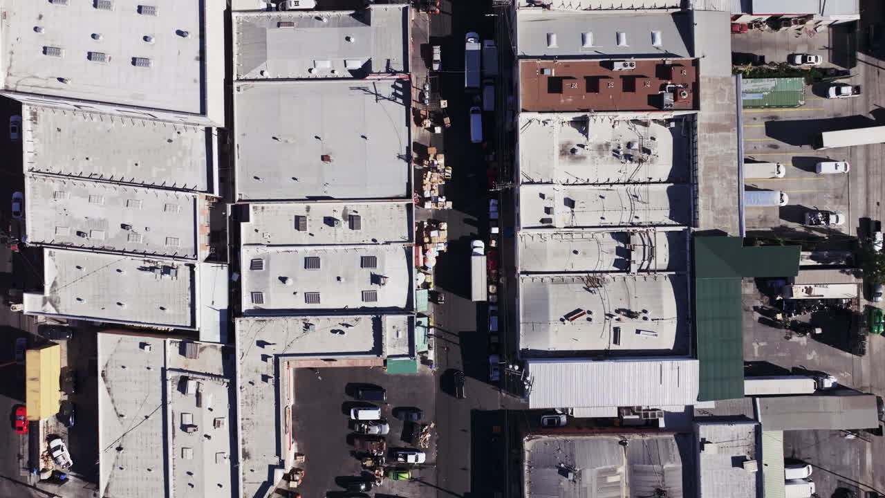Aerial top-down view of an urban industrial district with roads and vehicles