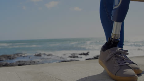 animation of scope scanning over woman with artificial limb standing by seaside