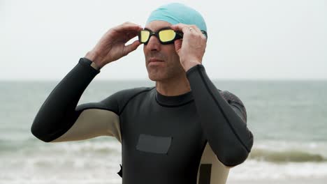 sportsman wearing goggles on beach