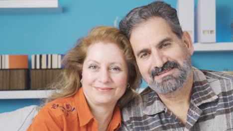 married and happy couple. they are looking at the camera.