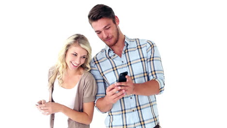 attractive young couple texting on phones